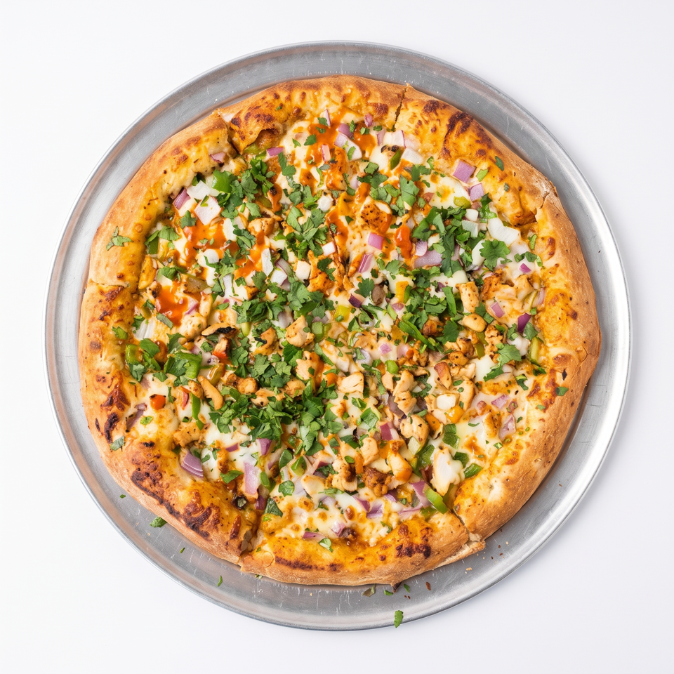 Round pizza topped with grilled chicken, melted cheese, cilantro, red onion, green peppers, and orange sauce on a metal tray.